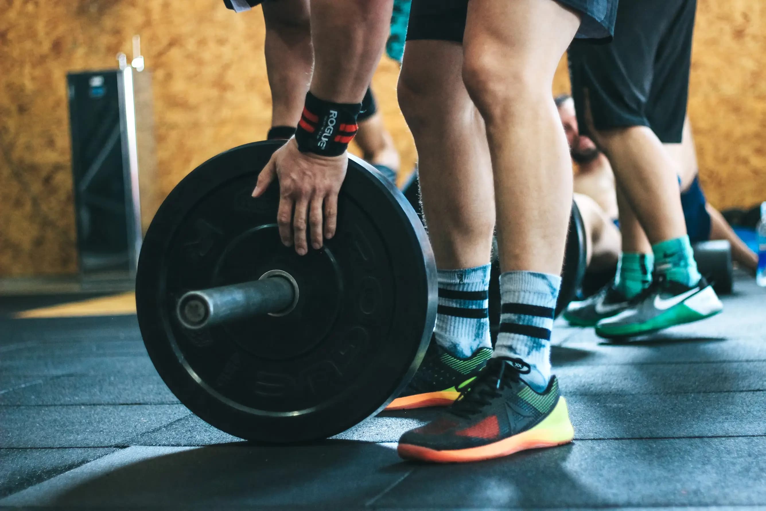 Someone loading plates onto a barbell