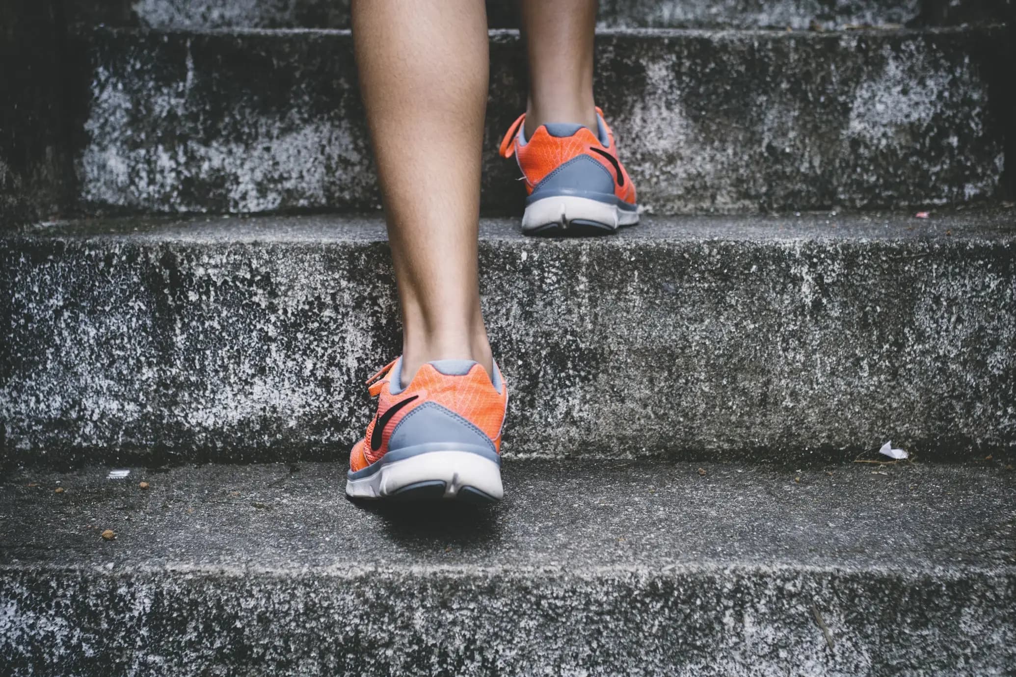 A close up of someone's trainers as they are climbing steps